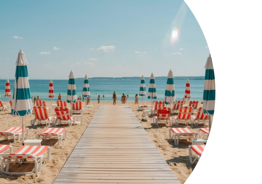 Beach front, with striped deck chairs and umbrellas.